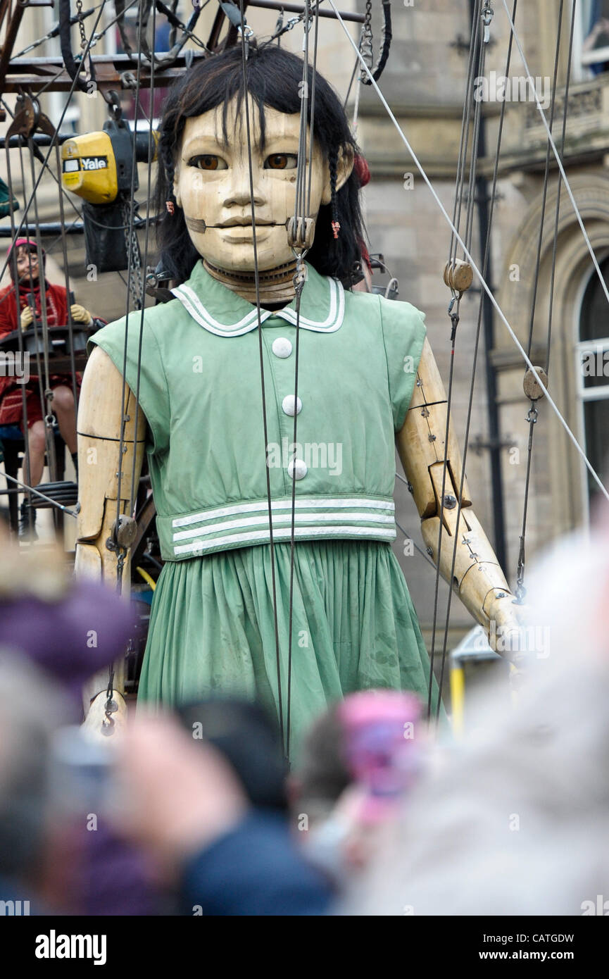Liverpool, UK. 20 April, 2012. A giant puppet of a girl walks through