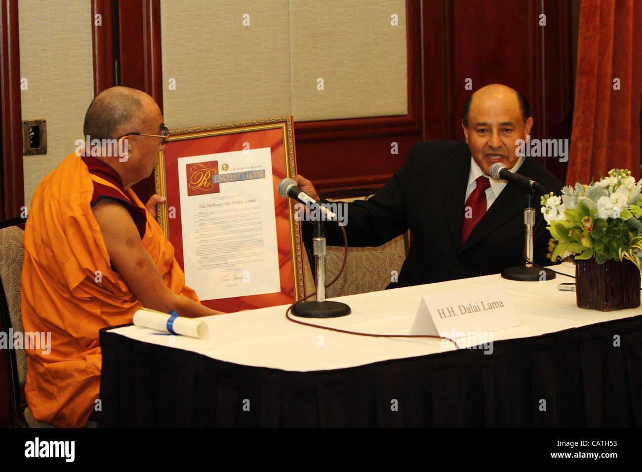 HH The XIV Dalai Lama receives a state resolution from California Senator Lou Correa, thanking the Dalai Lama for his 'lifelong efforts to world peace and improving the human conditions of the international community,' at the Westin Hotel in Long Beach, CA on Friday, Apri 20th 2012. During the press Stock Photo