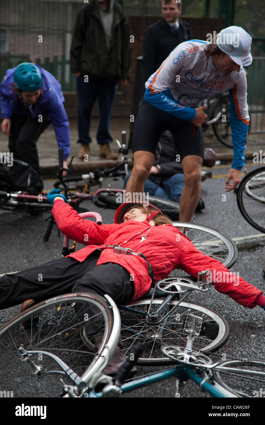 LONDON, UK, 23rd, Apr, 2012 One of the protesters lies on the floor during the die in protest outside the Addison Lee offices. Cyclists gathered outside the Addison offices to protest against the recent comments by the chairman, who claimed they are “throwing themselves onto (the road)” and that tra Stock Photo