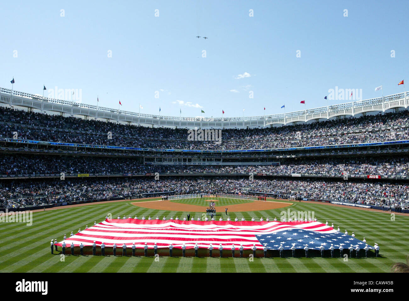 Opening ceremony, APRIL 13, 2012 - MLB : F-18 Super Hornet performs a flyover as a giant U.S. flag is unfurled on the field during pre-game ceremonies for the New York Yankees Home Opener at Yankee Stadium in Bronx, New York, United States. (Photo by Thomas Anderson/AFLO) (JAPANESE NEWSPAPER OUT) Stock Photo