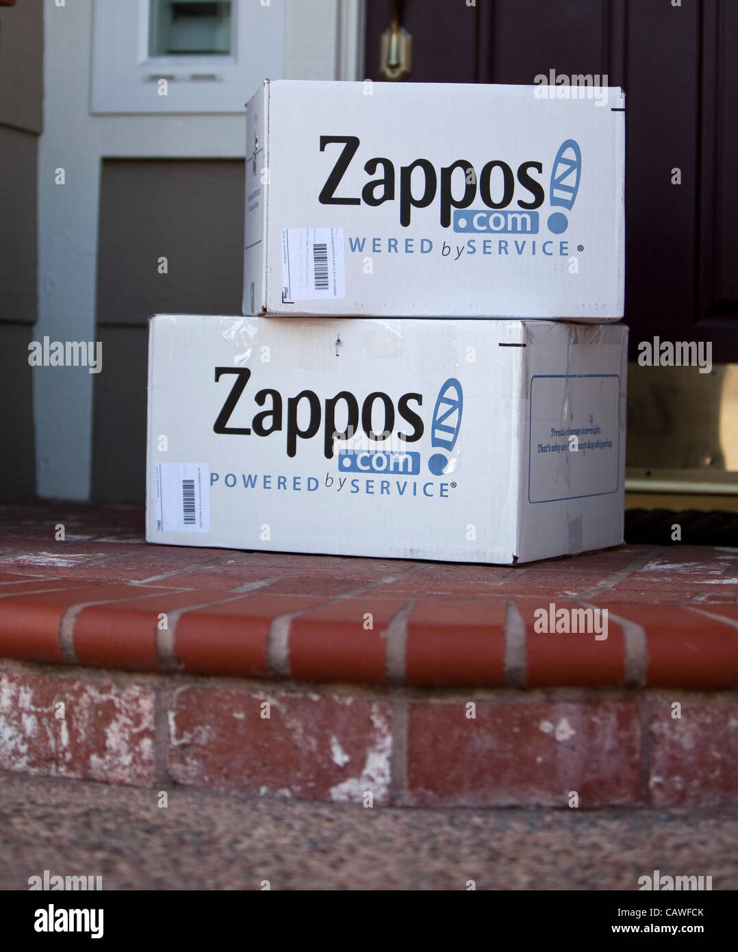 April 22, 2012 - Aliso Viejo, California, U.S. - White Zappos shipping boxes delivered to home in Southern California. Zappos.com is an online shoe and apparel shop currently based in Henderson, Nevada. Amazon bought Zappos in November 2009 for a reported $1.2 billion. Since its founding in 1999, th Stock Photo