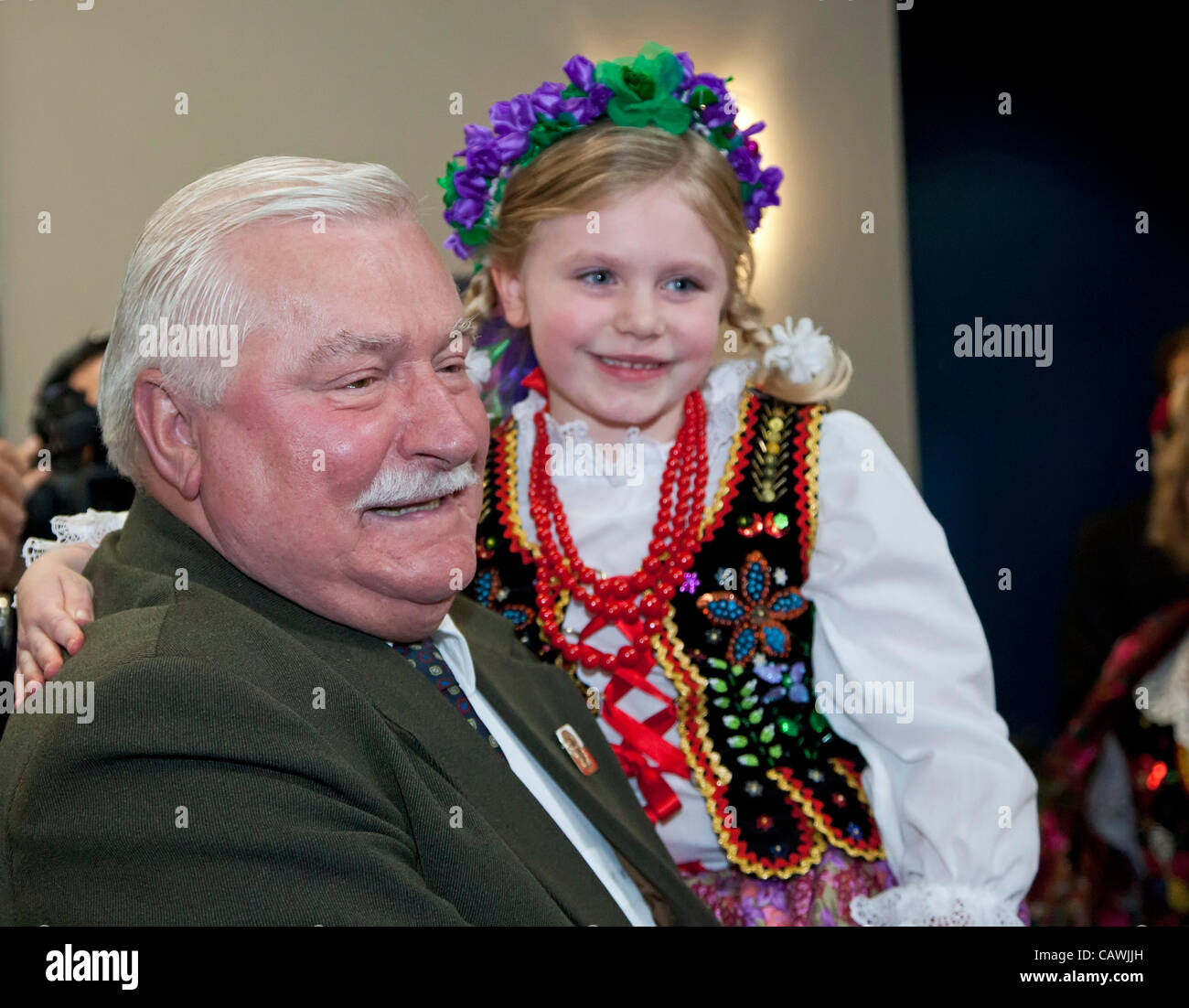 Detroit, Michigan - Lech Walesa holds Meredith Bayus, 5, of the Zamek Dance Troupe, as Walesa visits Chrysler's Jefferson North Assembly Plant. Walesa was a founder of the Solidarity trade union movement in Poland in 1980 and was elected president of Poland in 1990. He was awarded t Stock Photo