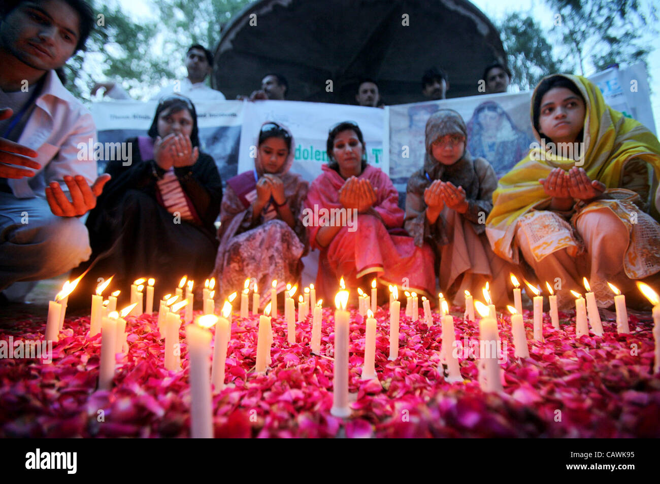 Activists of Civil Society offer Dua (pray) for passengers, who were lost their lifes in Bhoja Airline plane crash incident, during ceremony in their memory held in Peshawar on Friday, April 27, 2012. The incident took place on 20 April 2012 when Bhoja Air plane crashed w Stock Photo