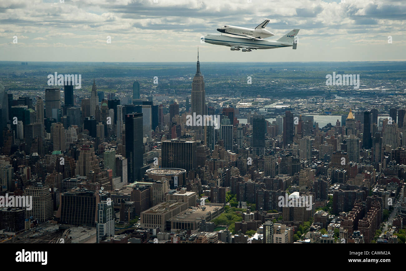 The NASA Space shuttle Enterprise mounted atop a NASA 747 Shuttle Carrier Aircraft flies near the Empire State Building April 27, 2012 in New York City. The Enterprise is being moved from the Smithsonian Museum to the Intrepid Sea, Air & Space Museum in New York. Stock Photo