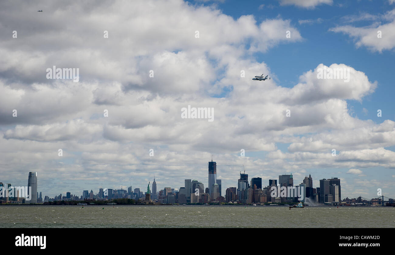 The NASA Space shuttle Enterprise mounted atop a NASA 747 Shuttle Carrier Aircraft flies near the Empire State Building April 27, 2012 in New York City. The Enterprise is being moved from the Smithsonian Museum to the Intrepid Sea, Air & Space Museum in New York. Stock Photo