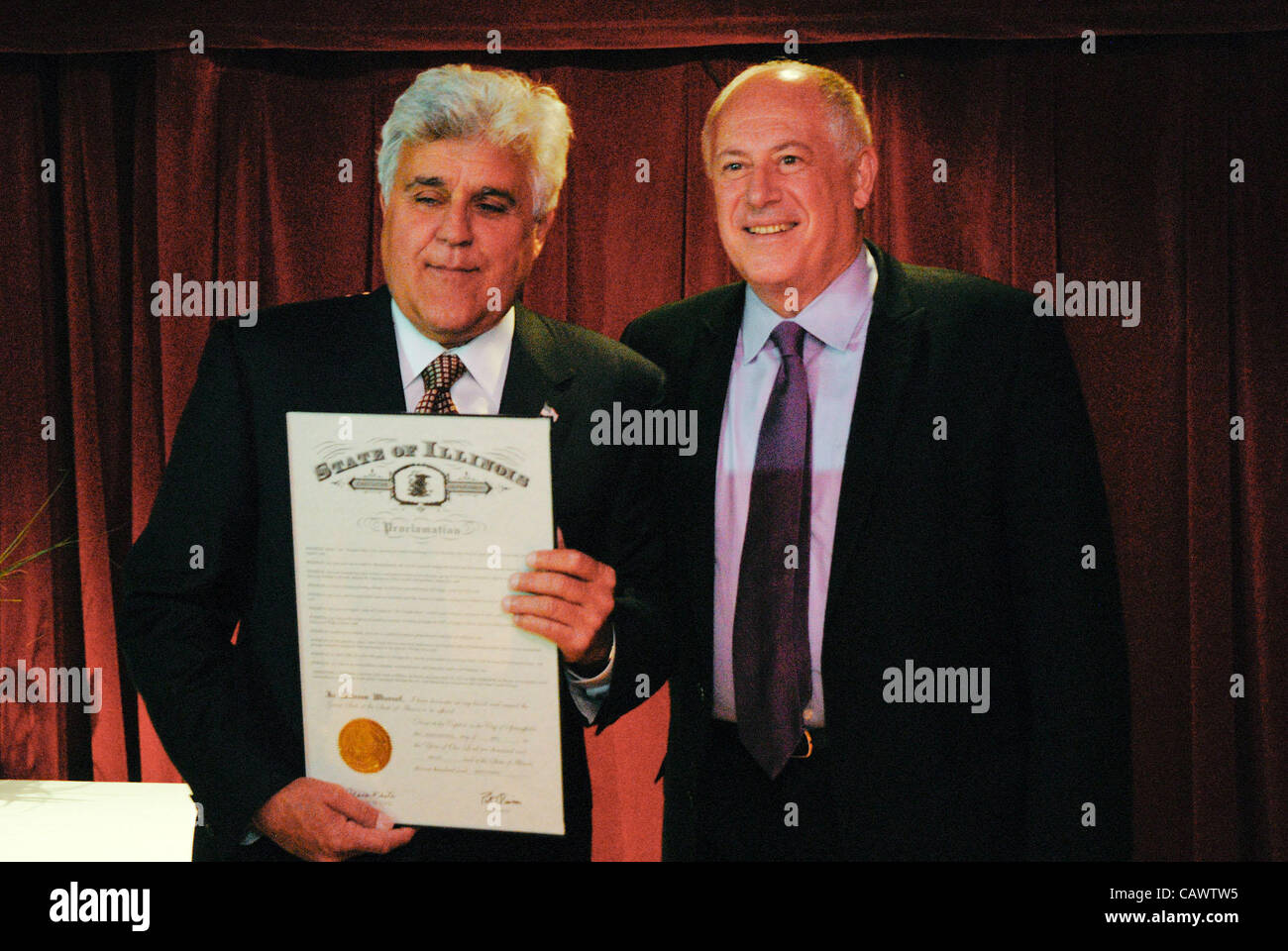Jay Leno receives a proclation from the Governor of Illinois declaring Jay Leno Day in the state.  It was presented at a benefit for Omni Youth Services on April 28th which happens to be Jay Leno's  birthday. Stock Photo