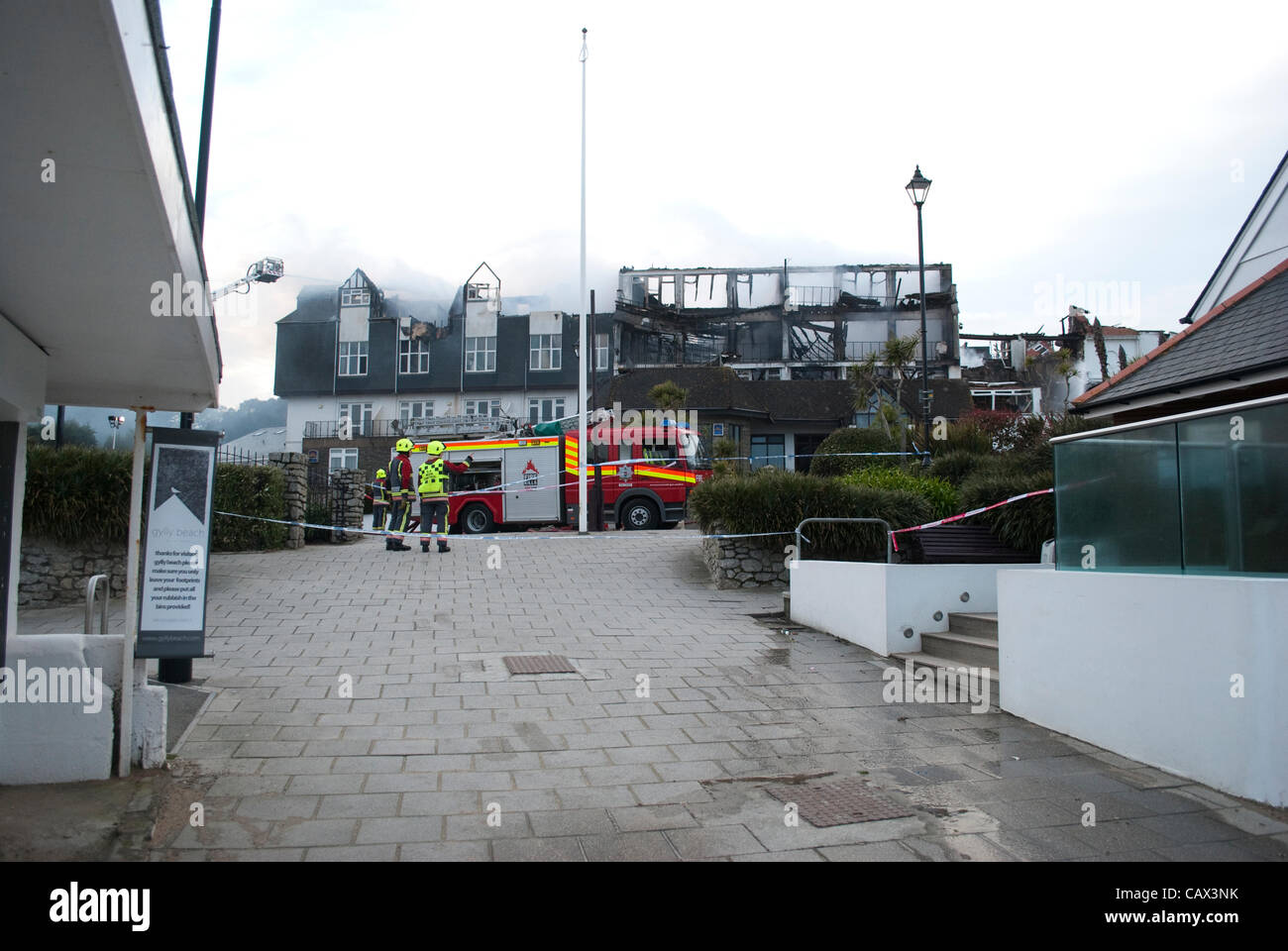 Two fire brigade members work on Falmouth's Best Western Seafront hotel is destroyed in a blaze on the 30.04.12 Stock Photo
