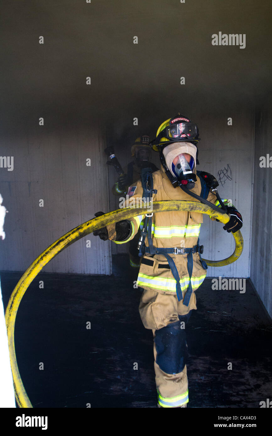March 3, 2012 Modesto, CA, USA Firefighters pull more after putting