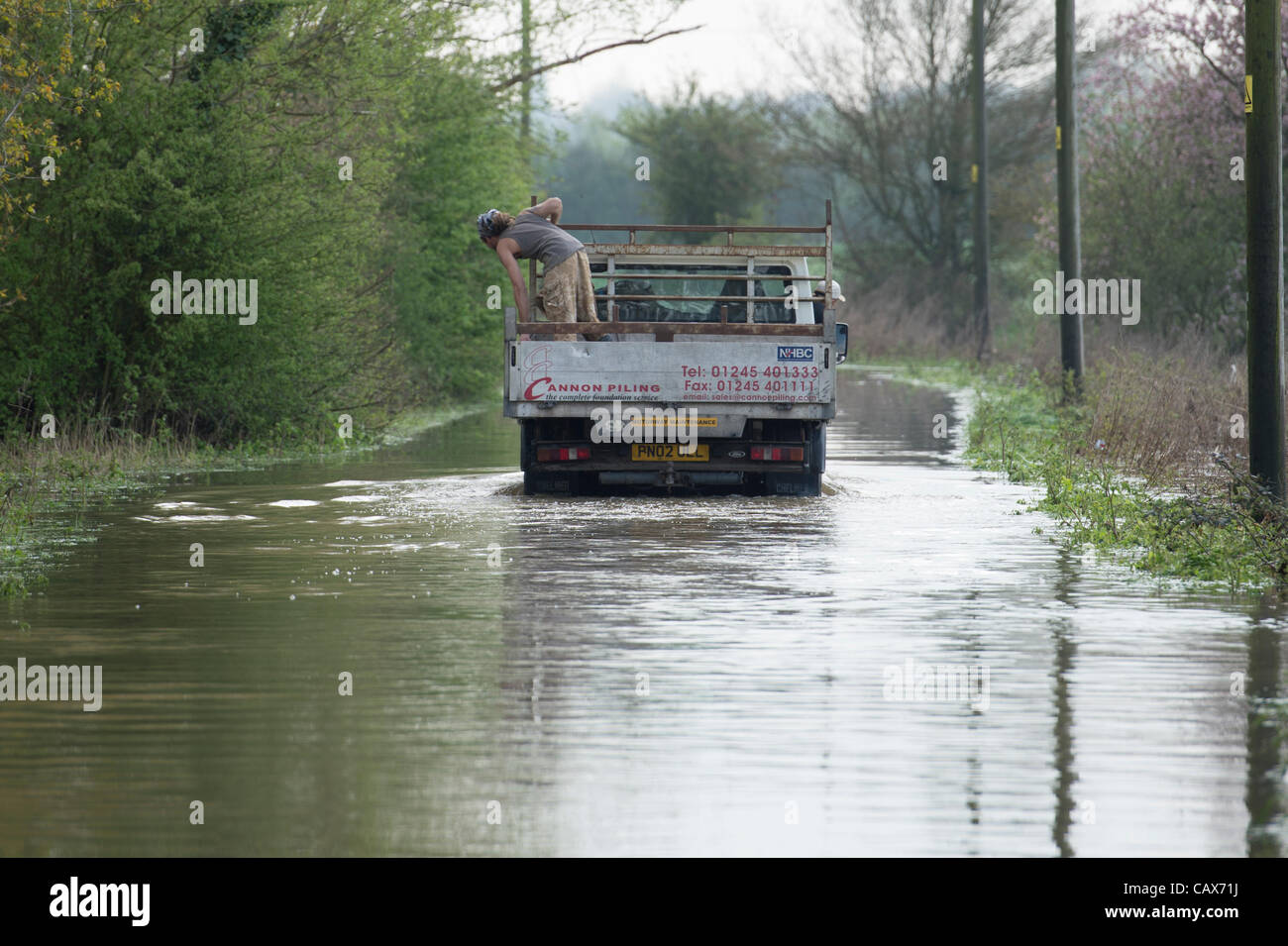 1st May 2012, Billericay, Essex, UK. Truck travels through flood water as passenger and driver check depth. Torrential rain has lead to local flooding that has become worse even though rain has stopped due to run-off from surrounding fields. Stock Photo