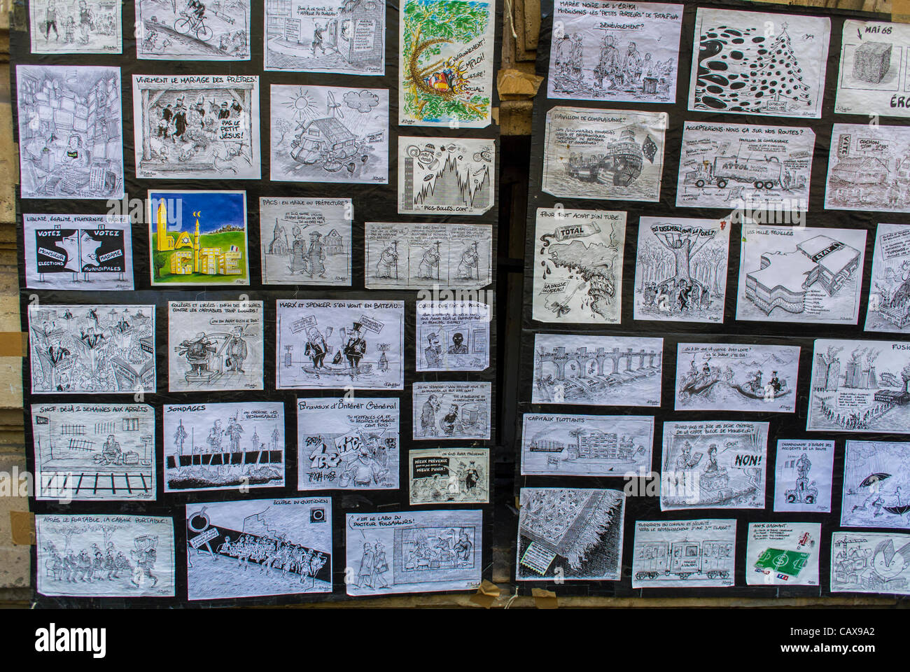 Paris, France, French Political Cartoons on Display on Wall on Street during  Trade Unions Demonstration May Day Events, protest art Stock Photo