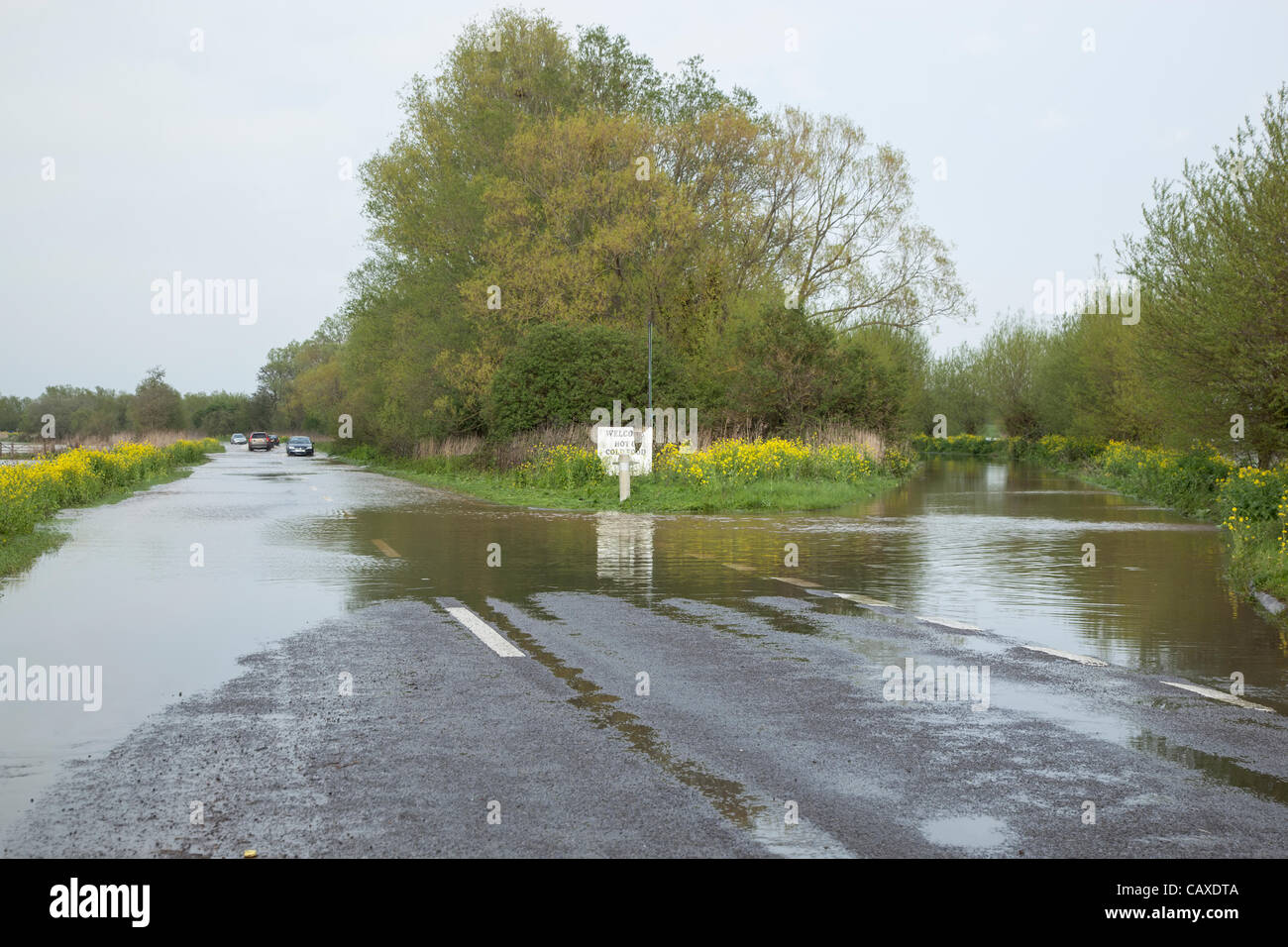 Cars pass through flood water on the main A361 from Taunton to Glastonbury near Athelney on 2 May 2012 . The road and layby were closed briefly as it became impassable due to the continuous rain which has caused widespread flooding across the Somerset Levels despite the official drought declaration. Stock Photo