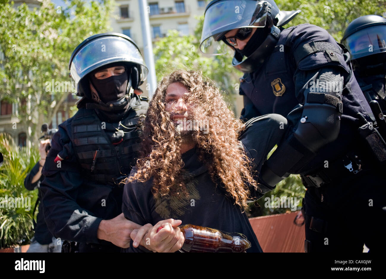 03 may, 20120-Barcelona, Spain. A man is detained by riot police during the march organized by students protesting cuts in public education. The march coincided with the visit of the European Central Bank in Barcelona which is why the city is strongly taken by the police (Photo ©Jordi Boixareu) Stock Photo