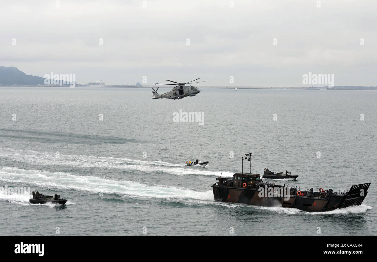 HMS Bulwark, Royal Navy flagship, Britain, UK, landing craft and rapid response boats and Merlin helicopter from the ship Stock Photo