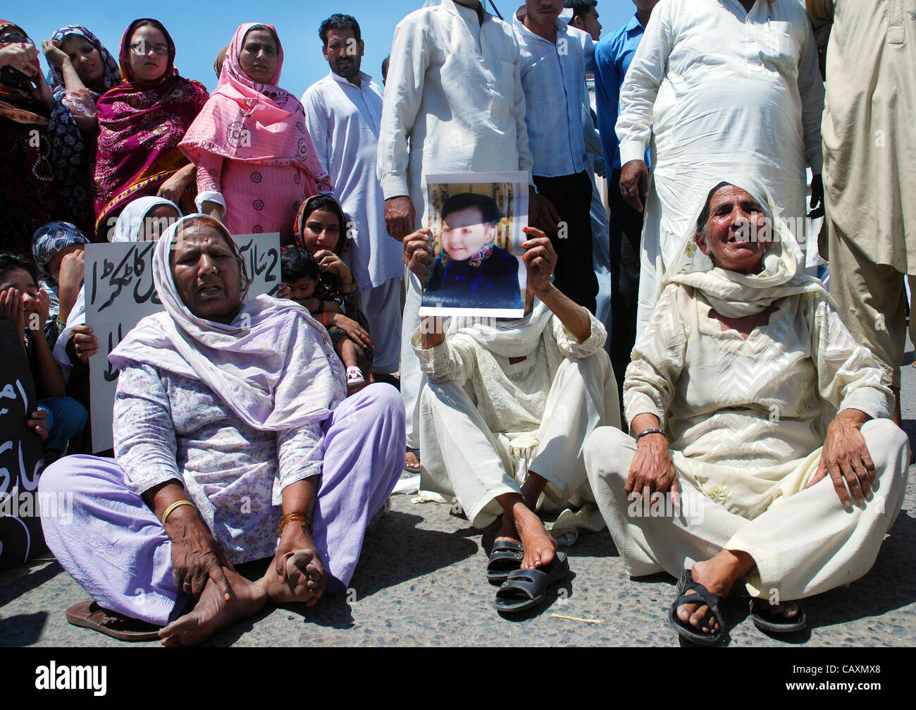 Relatives of two-year-old Amna are protesting for her recovery during demonstration at GT.road in Gujranwala on Friday, May 04, 2012 Stock Photo