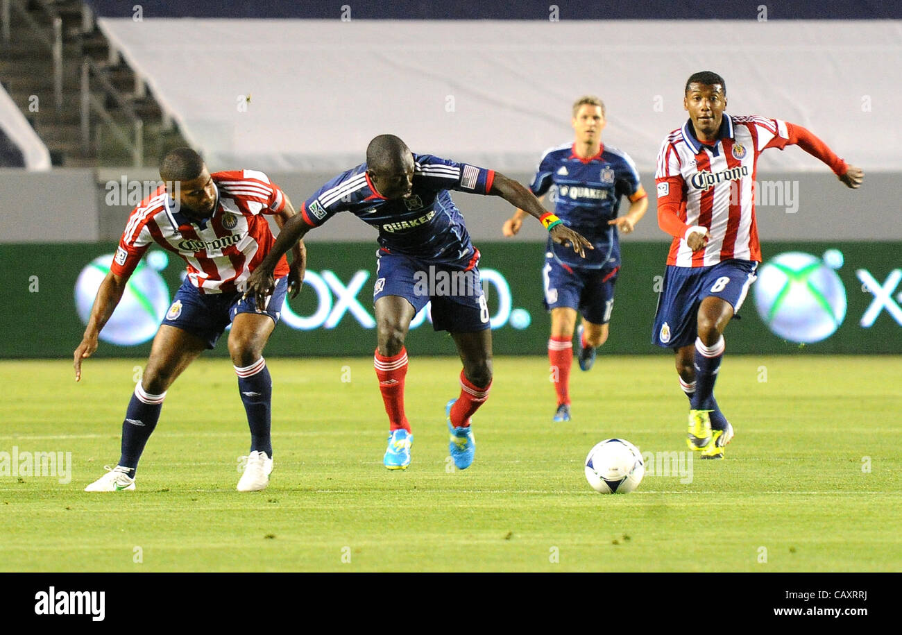 May 5, 2012 - Carson, California, USA - MLS Soccer- CHIVAS USA players RAUWSHAN MCKENZIE[4] and OSWALDO MINDA [8] race CHICAGO FIRE forward [8] DOMINIC ODURO  for the ball at mid field as the CHICAGO FIRE defeated CHIVAS USA 2 to 1 at the Home Depot Center, Carson, California, USA, May 4, 2012.   Ch Stock Photo