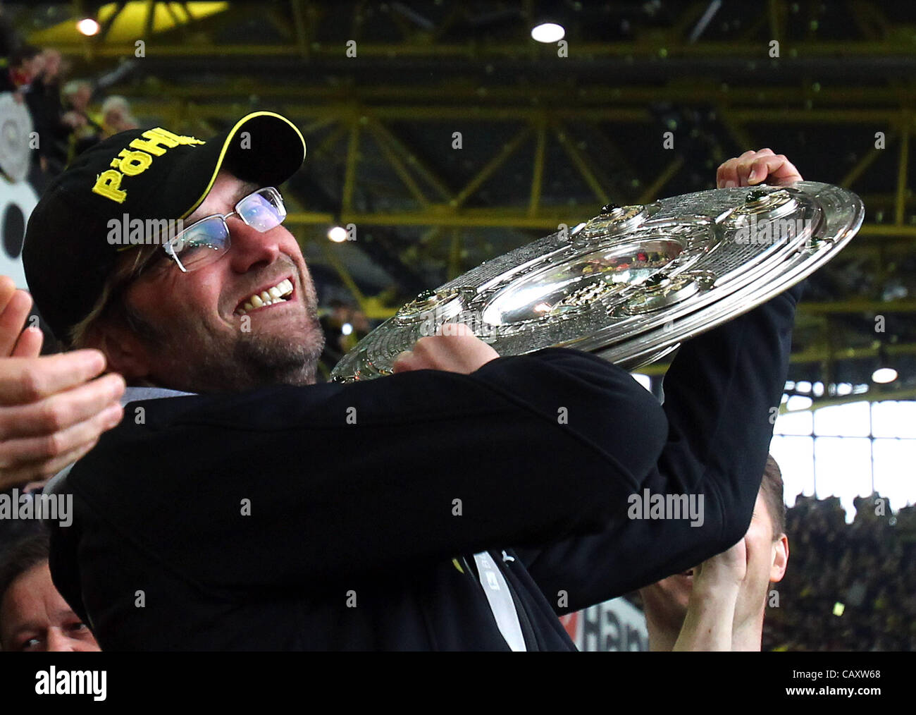 DORTMUND, GERMANY - MAY 05:  Juergen Klopp, head coach of Dortmund lifts the trophy after winning the german championship after the Bundesliga match between Borussia Dortmund and SC Freiburg at Signal Iduna Park on May 5, 2012 in Dortmund, Germany. Stock Photo