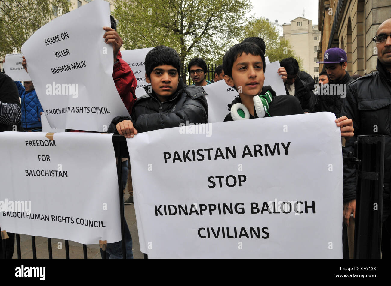 Young boys and men holding banners with slogans 'Freedom for Balochistan' and 'Pakistan army stop kidnapping Baloch civilians' outside Downing Street as part of the protest against forced marriages and conversion in Pakistan. Sunday 6th May 2012. Stock Photo