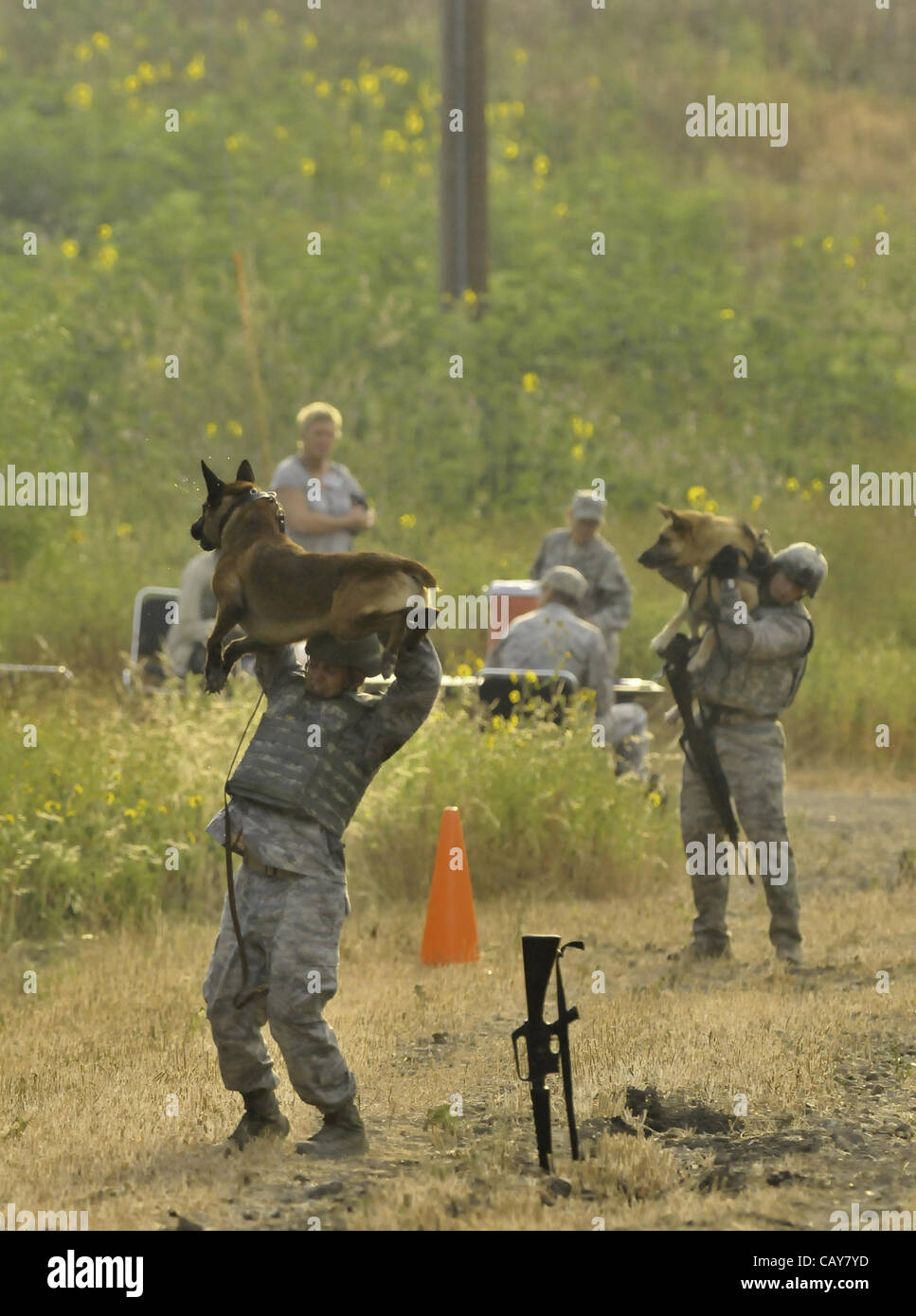 May 5, 2012 Sgt. Elizabeth Wenke hugs her dog following the Iron Dog