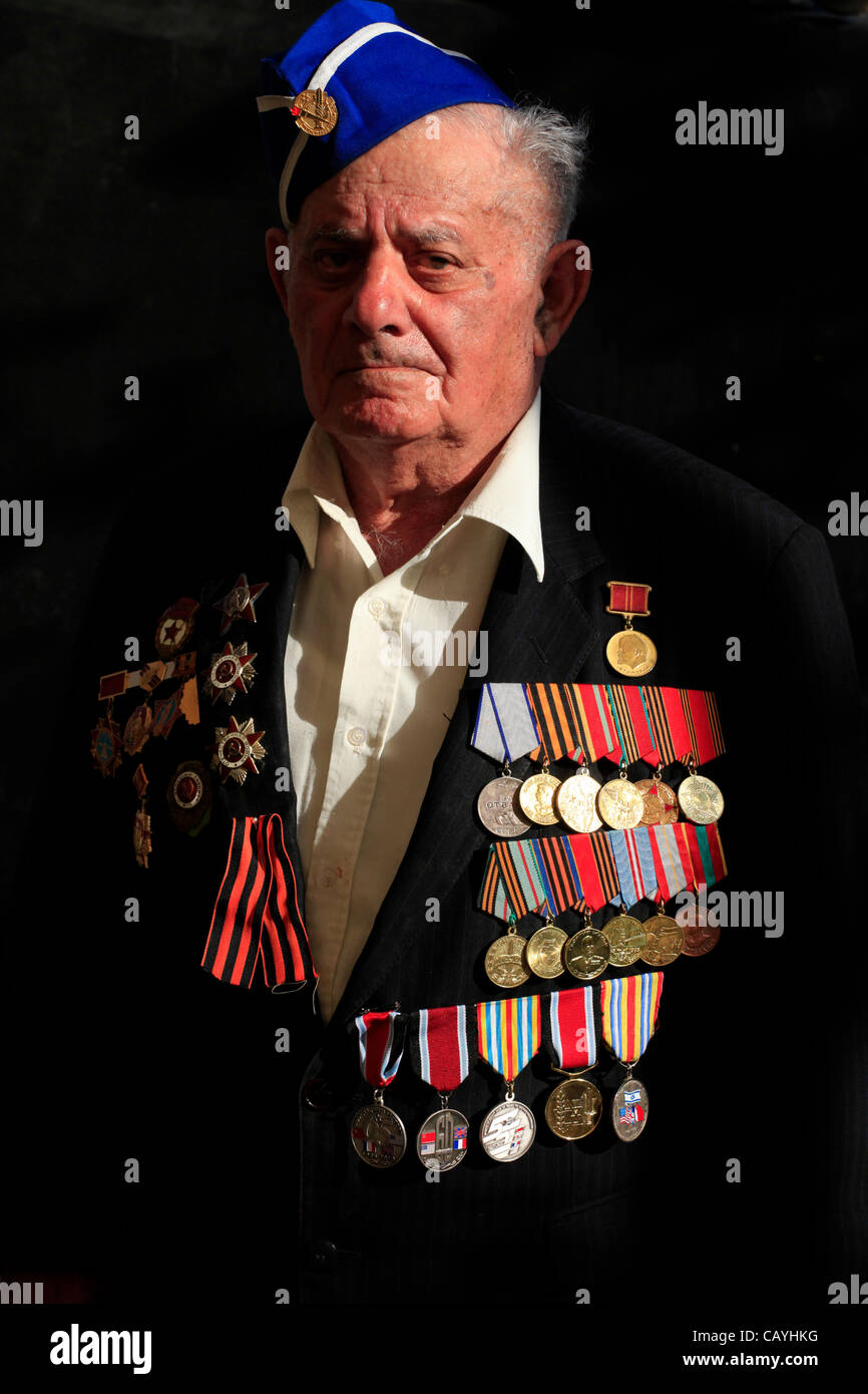 A soviet Jewish World War II veteran with medals pinned in his suit coat during ceremony marking the Allied Victory over Nazi Germany in Israel Stock Photo