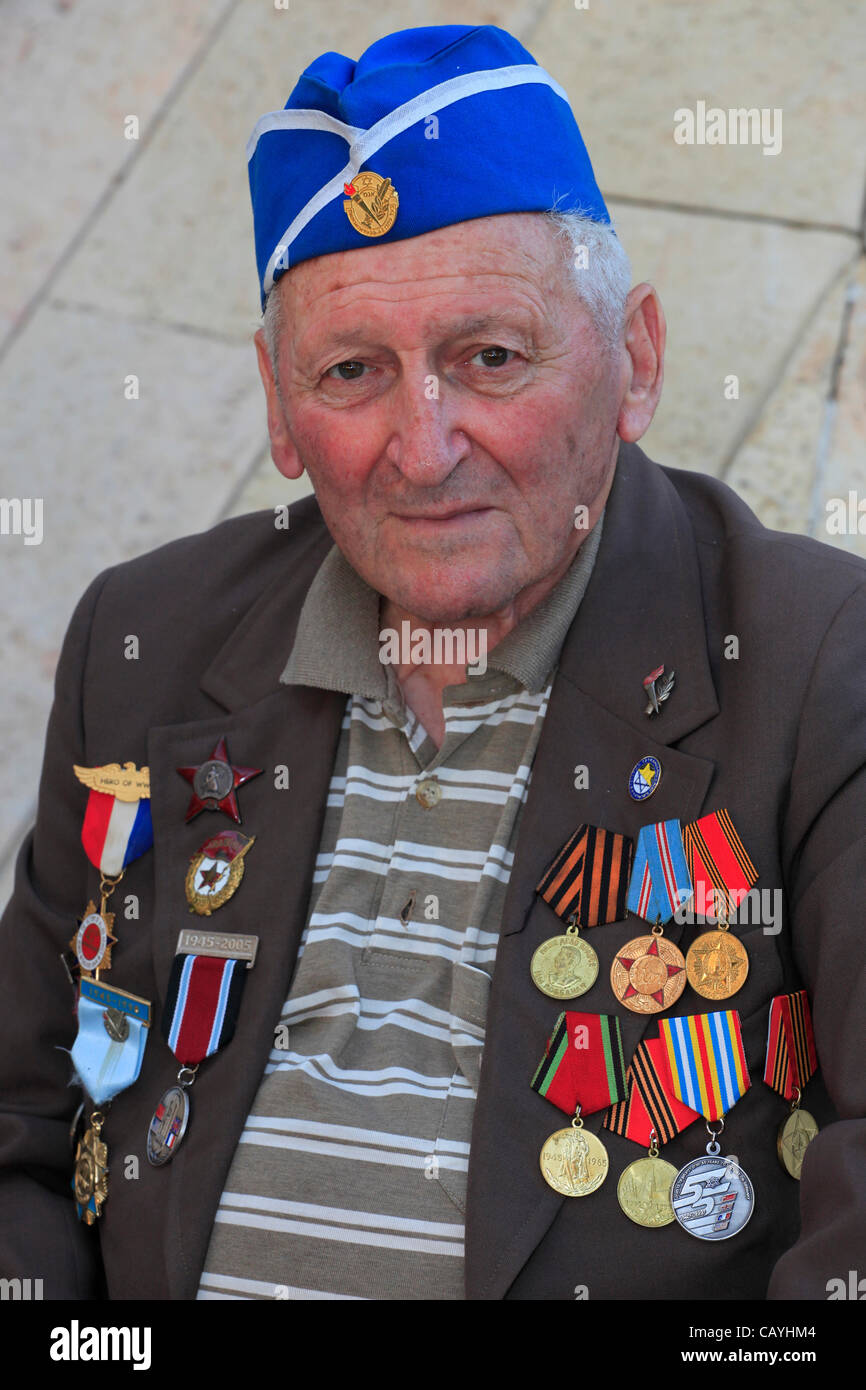 A soviet Jewish World War II veteran with medals pinned in his suit coat during ceremony marking the Allied Victory over Nazi Germany in Israel Stock Photo