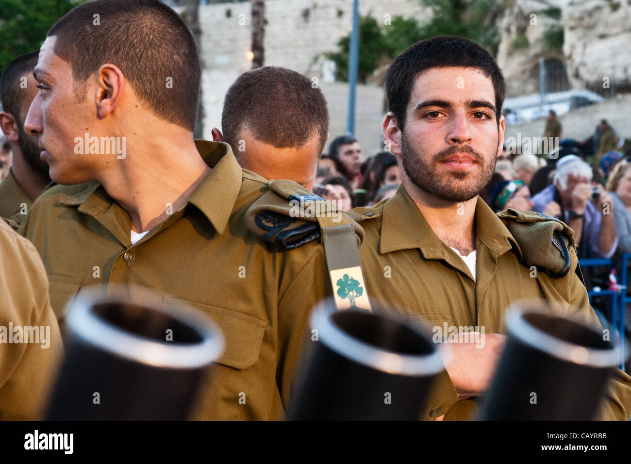 A Golani Brigade IDF soldier stares at camera. Three M203 grenade launcher muzzles are evident in the foreground. Jerusalem, Israel. 10-May-2012. Stock Photo