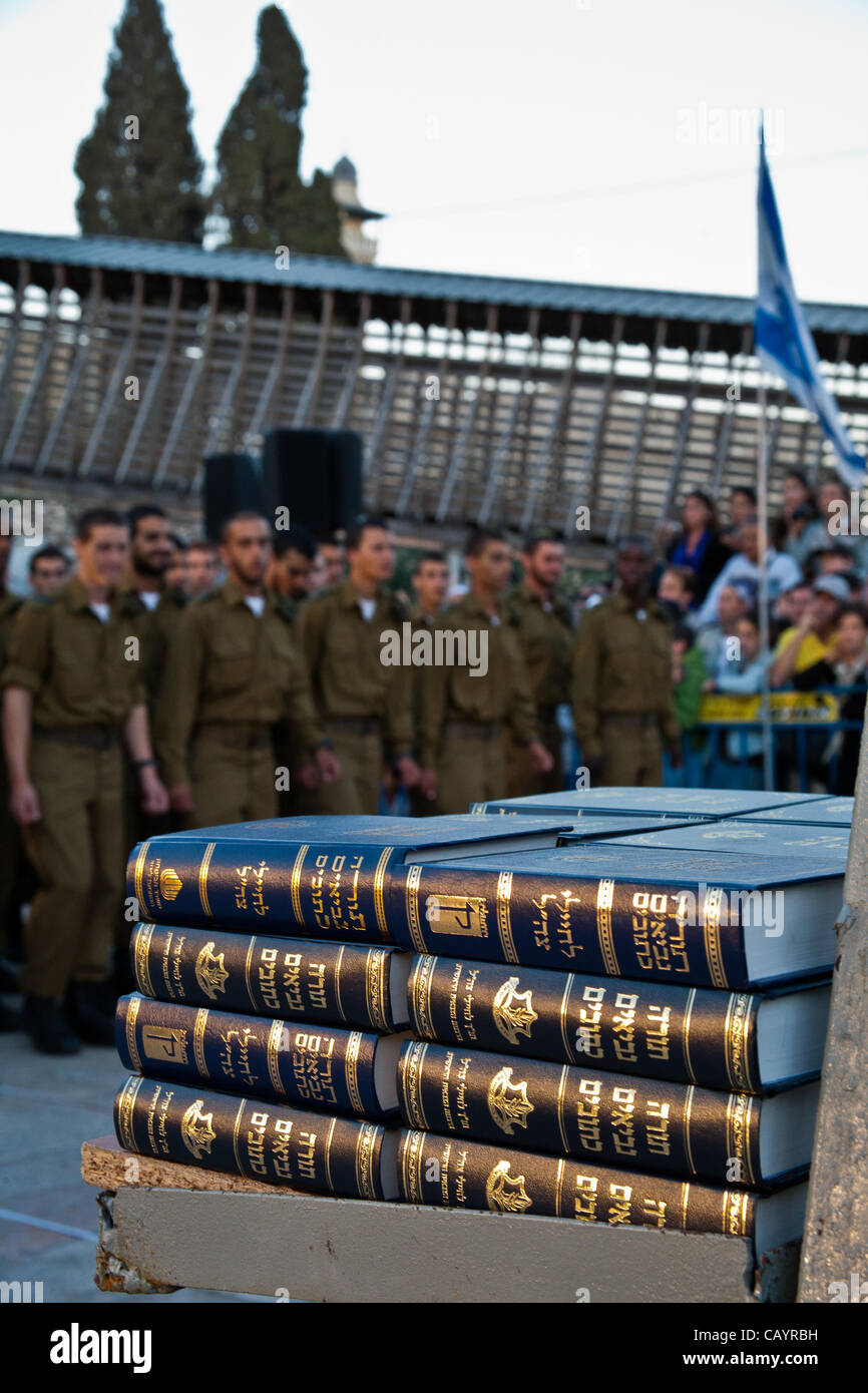A stack of bibles awaits distribution to soldiers of the Golani Brigade after they swear allegiance to state and IDF in a ceremony about to begin. Bibles are also customarily awarded at school graduations thus most Israeli families have a collection. Jerusalem, Israel. 10-May-2012. Stock Photo