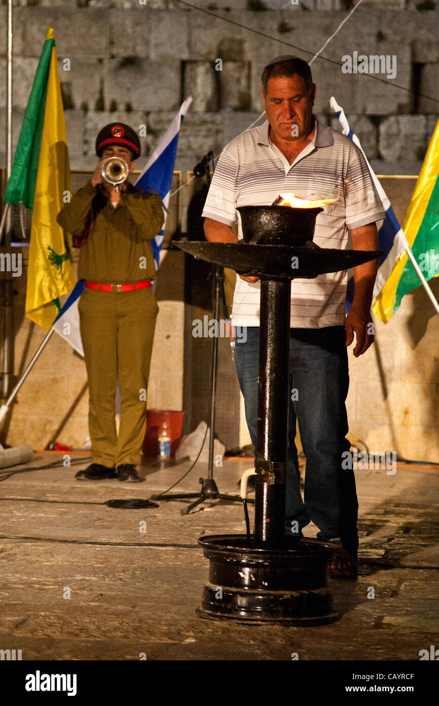 A bereaved father lights a torch in memory of Golani Brigade soldiers killed in action at onset of ceremony at the Western Wall. Jerusalem, Israel. 10-May-2012. Stock Photo