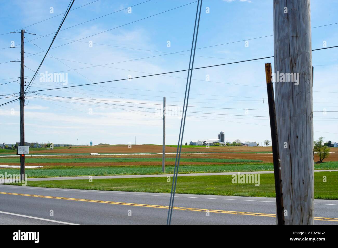 A farm is seen through intersecting power and telephone lines in New ...