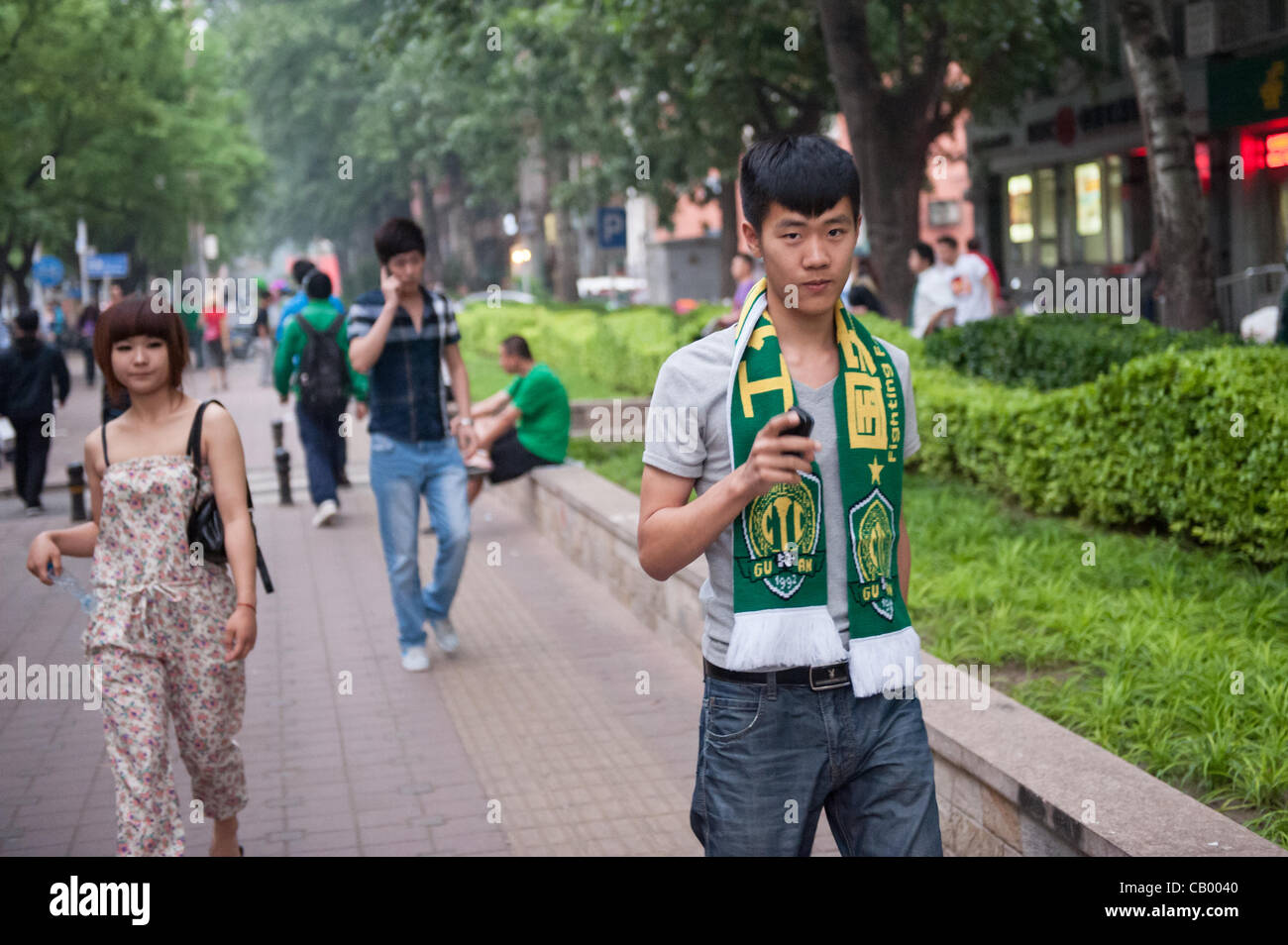 Supporter of Beijing Guoan on his way to the Workers' Stadium for the match between the Beijing Guoan and Guizhou Renhe football teams in Beijing, China, on Friday May 11, 2012. Beijing Guoan won the match with 2:1. Stock Photo