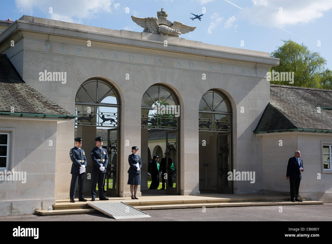 The main entrance of the Runnymede Commonwealth Air Forces Memorial overlooked by the RAF Eagle while a jet aircraft flys overhead and RAF personnel wait to welcome attendees to the Memorial Service held at Egham, England on the 13th May'12 Stock Photo