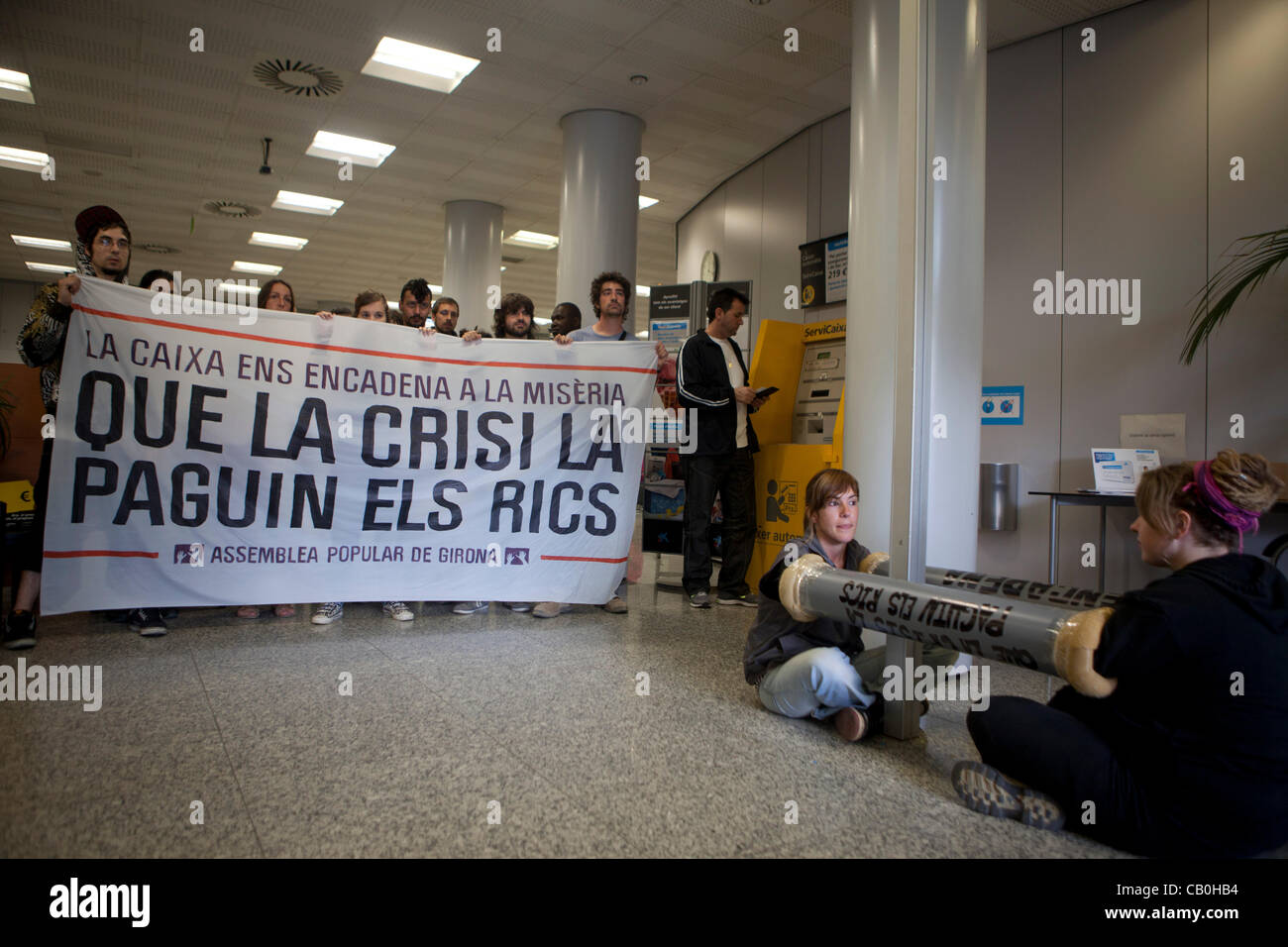 15M-anti-capitalist movement in Spain: Peaceful occupation of a branch of La Caixa bank in Spain Girona, young people occupy Stock Photo