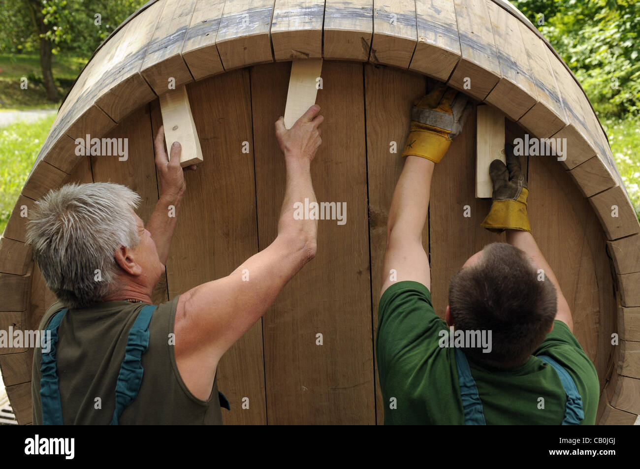 Coopers roll make a giant wooden barrel in the Pilsner Urquell brewery in Plzen (Pilsen) on May 15, 2012. The brewery still uses traditional woooden barrels for a small part of its production. (CTK Photo/Petr Eret) Stock Photo