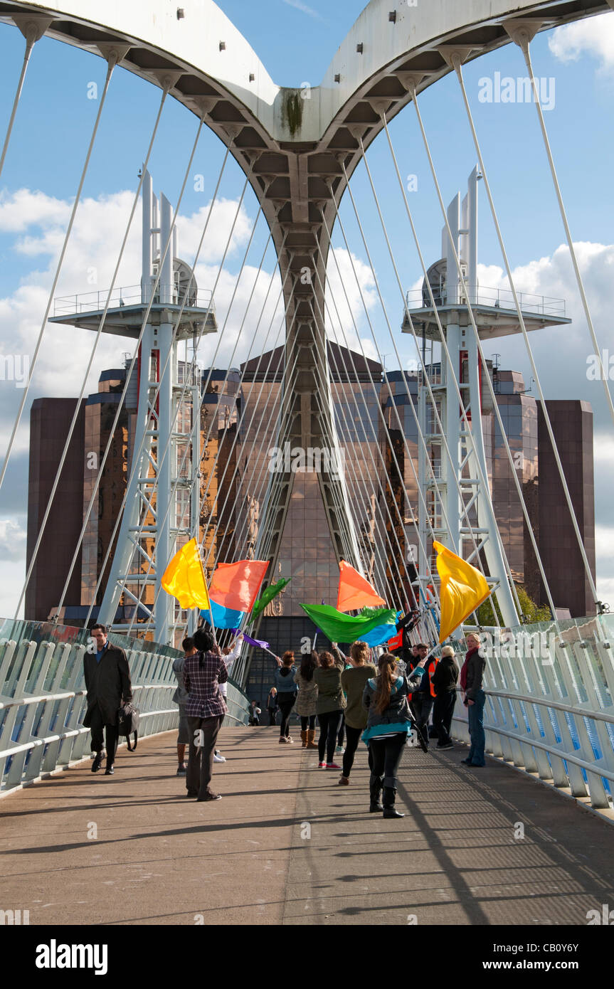 A group of young people rehearse a flag waving routine for the Looping the Loop event at Salford Quays, held on Saturday 19th May. The event marked the start of the London 2012 'Games Time' in North West England and the first day of the Olympic torch relay in the UK. Stock Photo
