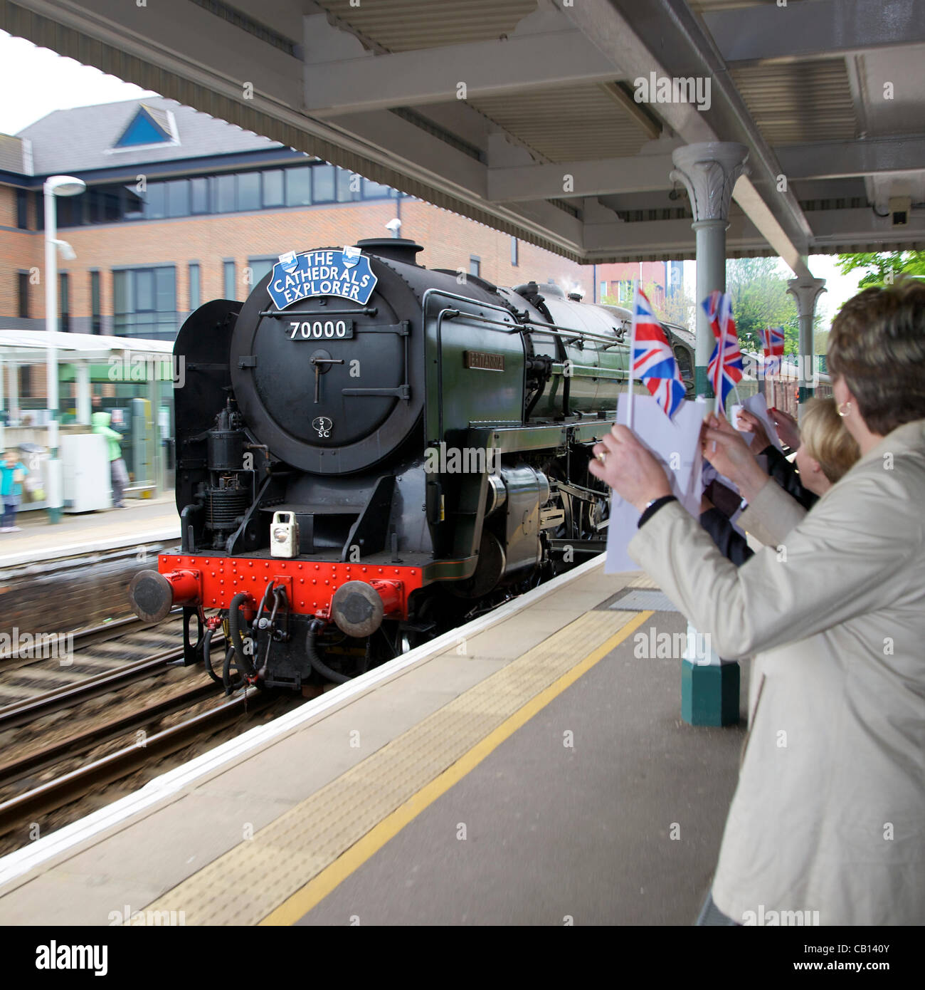 Welcomed by excited flag waving crowds as it passed Reigate Station in Surrey at 0903hrs Friday 18th May 2012 is 'Cathedrals Explorer' Britannia Class 7MT 4-6-2 no 70000 Britannia steam locomotive en route to Durham on an 8 day tour. With 67026 DB Schenker Class Diesel 'Diamond Jubilee' at the rear Stock Photo