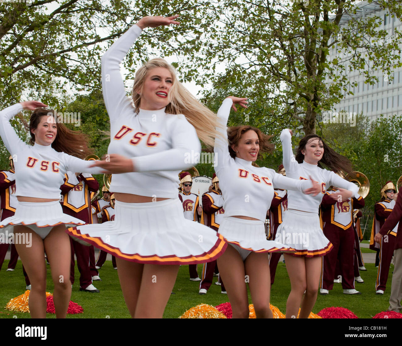 18 May 2012 London UK, The Cheerleaders of University of Southern California Trojans Marching Band show off their skills but fail to bring the sun on Potters Field in London, UK. The performance which was part of their pre-Olympic tour of London. Stock Photo