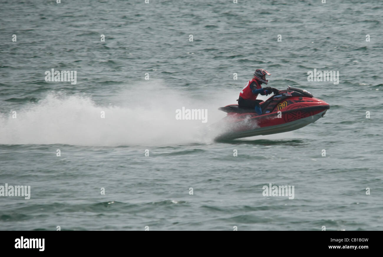 A P1 jet ski racer, speeds across Plymouth Sound during the first day ...