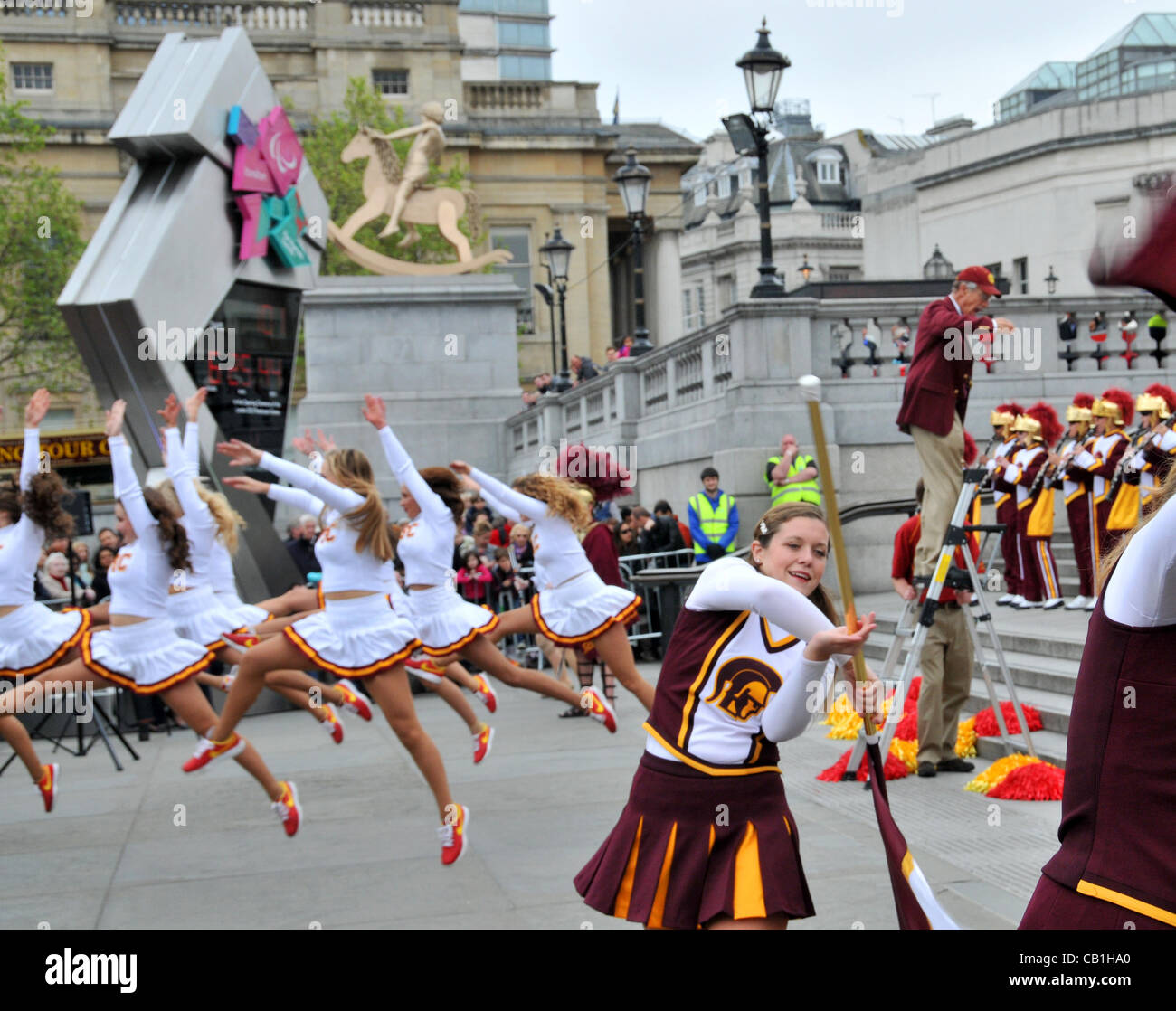 London, UK. 20/05/2012. Cheerleaders of the University of Southern California (USC), Trojans Football Team and the Marching Band in front of the Olympic Clock in Trafalgar Square. Stock Photo