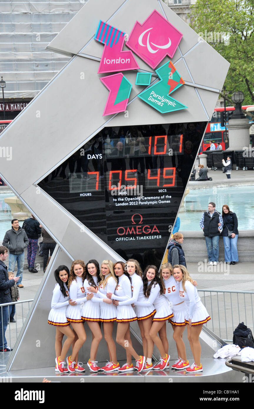 London, UK. 20/05/2012. Cheerleaders of the University of Southern California (USC), Trojans Football Team Marching Band in front of the Olympic Clock in Trafalgar Square. Stock Photo