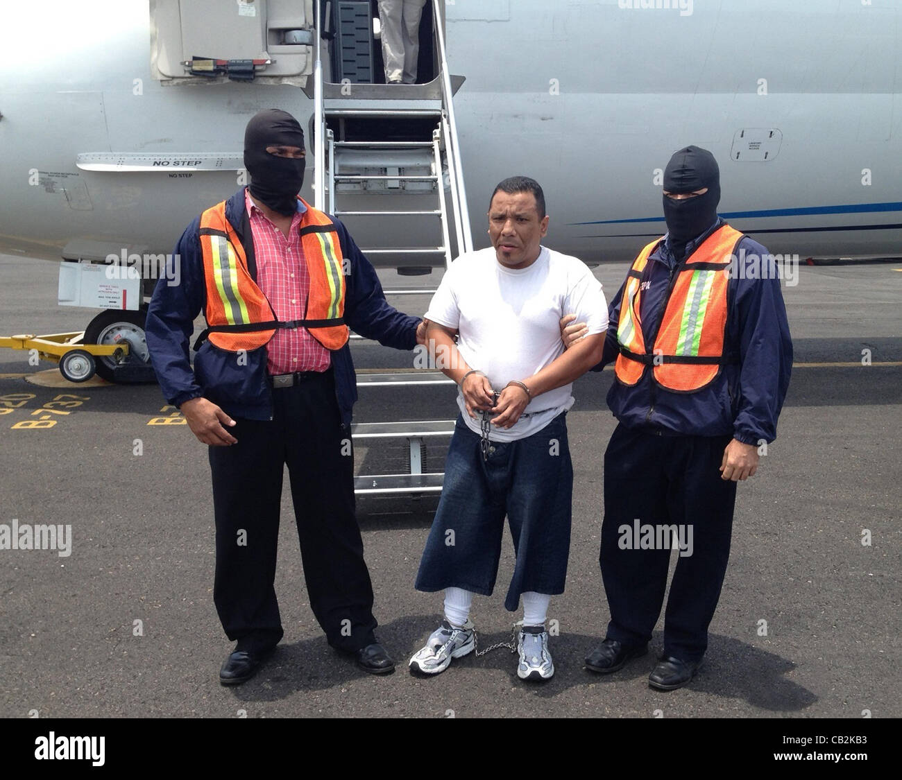 Tarsis Dodamin Quintero-Sanchez, 40, a member of the 18th Street Gang is escorted off a ICE removal flight May 23, 2012 in San Salvador.  Sanchez is wanted in El Salvador for aggravated homicide was deported by U.S. Immigration and Customs Enforcement. Stock Photo