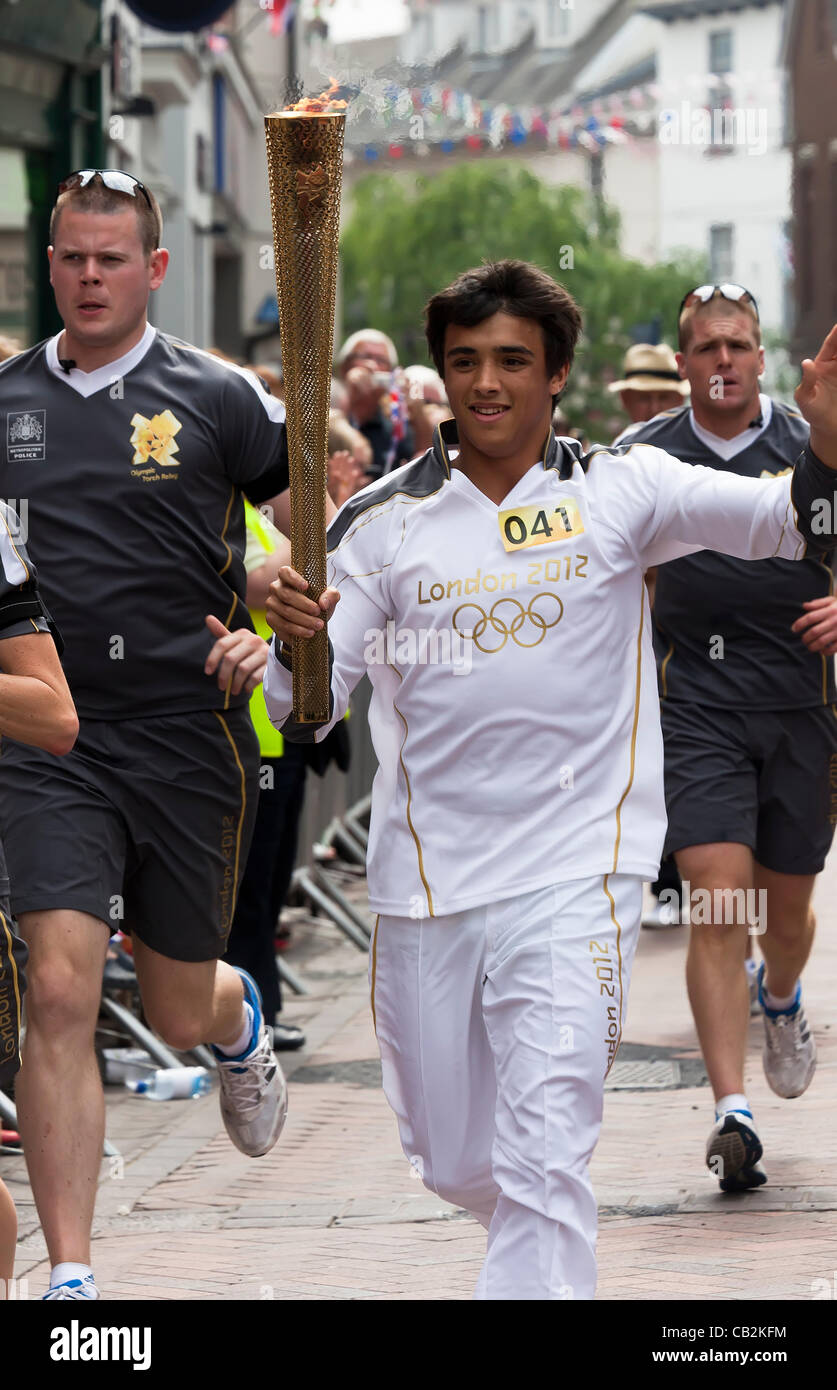 George Ryley age 17 from Monmouth carrying the flame during the Torch relay for the London 2012 Olympics through Abergavenny, Wales, UK on Friday 25 May 2012 Stock Photo