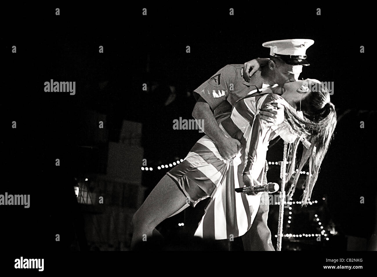 A US Marine kiss singer, Katy Perry on stage during the opening night block party for Fleet Week New York May 24, 2012 in New York, NY. In honor of the troops Perry pulled one Marine on stage to recreate the iconic V-J Day Kiss photo from 1945 . The Marine grabbed Katy, dipped her back and gave her Stock Photo