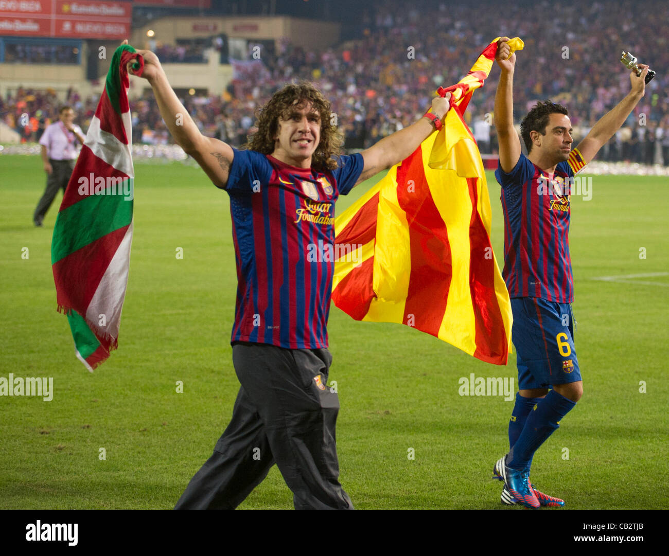 MADRID, SPAIN - MAY 25:  Carles Puyol an Xavi Hernandez, from F.C.Barcelona, greet supporters holding flags after beating Athletic de Bilbao in the Copa del Rey Final for 3-0 at Vicente Calderon Stadium on May 25, 2012 in Madrid, Spain. (Credits : J.M.Colomo/GRUPPO) Stock Photo