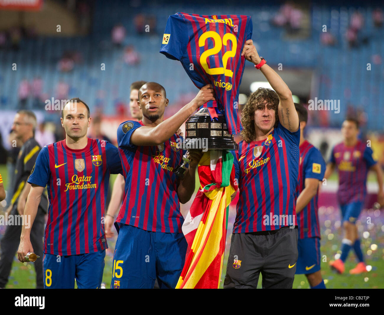 MADRID, SPAIN - MAY 25:  Seidou Keita and Carles Puyol from F.C.Barcelona,  hold the trophy wearing their injured teammate Abidal's shirt after beating Athletic de Bilbao in the Copa del Rey Final for 3-0 at Vicente Calderon Stadium on May 25, 2012 in Madrid, Spain. (Credits : J.M.Colomo/GRUPPO) Stock Photo
