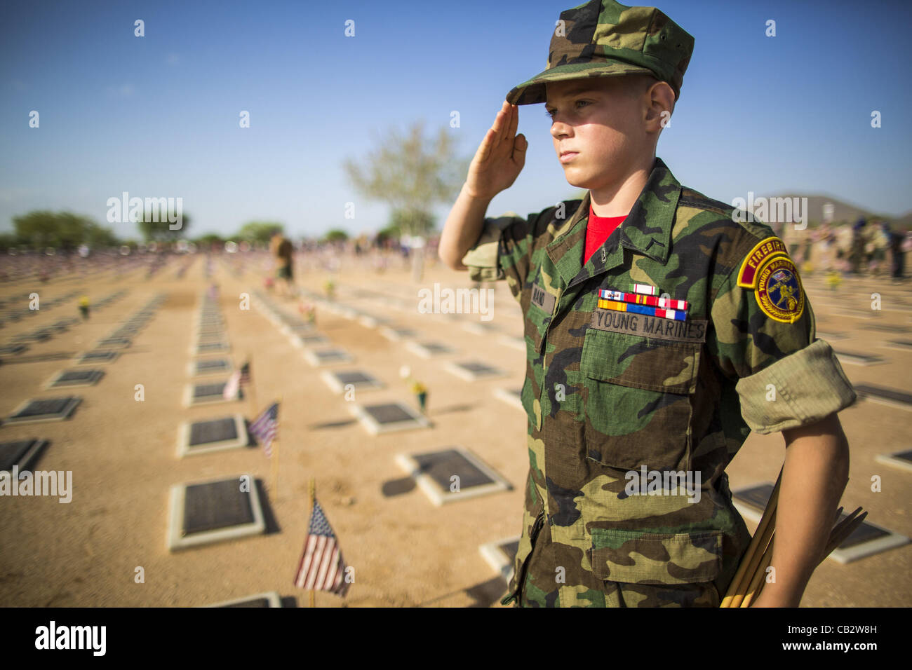 May 26, 2012 KEVYNN BRAND, a member of the Firebirds Young Marines, from Phoenix, AZ, salutes after placing an American flag on a veteran's grave at the National Memorial Cemetery in Phoenix, AZ. Credit Line : Credit:  ZUMA Press, Inc. / Alamy Live News Stock Photo