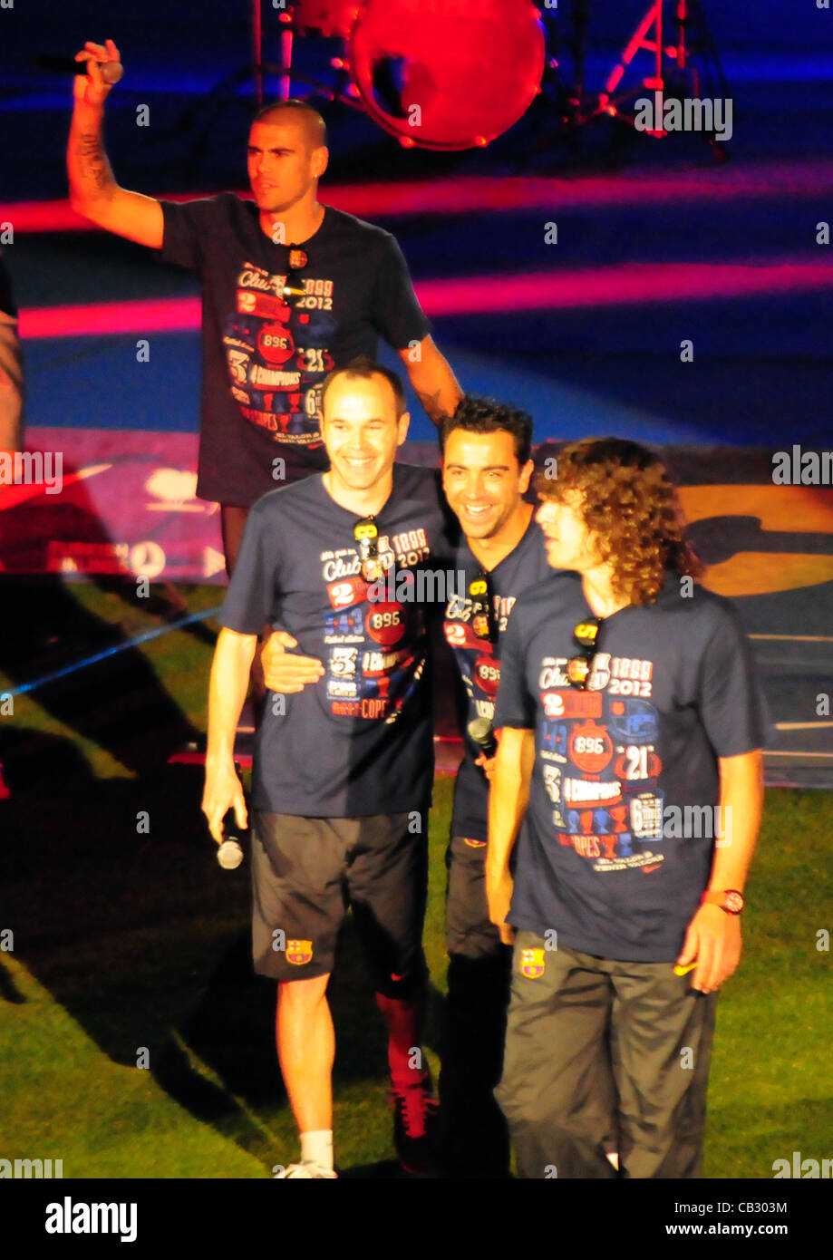 FC Barcelona trophy presentation to the fans (Barcelona, may 26 2012) The four captains of of FC Barcelona (from left to right, Victor Valdes, Andres Iniesta, Xavi Hernandez and Puyol) walk off the stage after speaking to the fans in a ceremony held after winning the Copa del Rey. Stock Photo