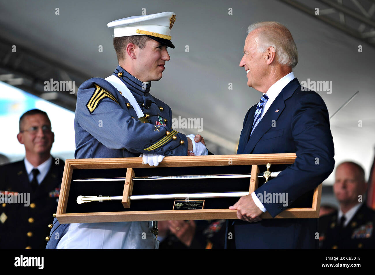 Vice-President Joe Biden receives the West Point Cadets' Sword from cadet Maxwell Love as a token of appreciation from Class 2012 during their graduation at the U.S. Military Academy May 26, 2012 in West Point, NY. Biden was the keynote speaker. Stock Photo