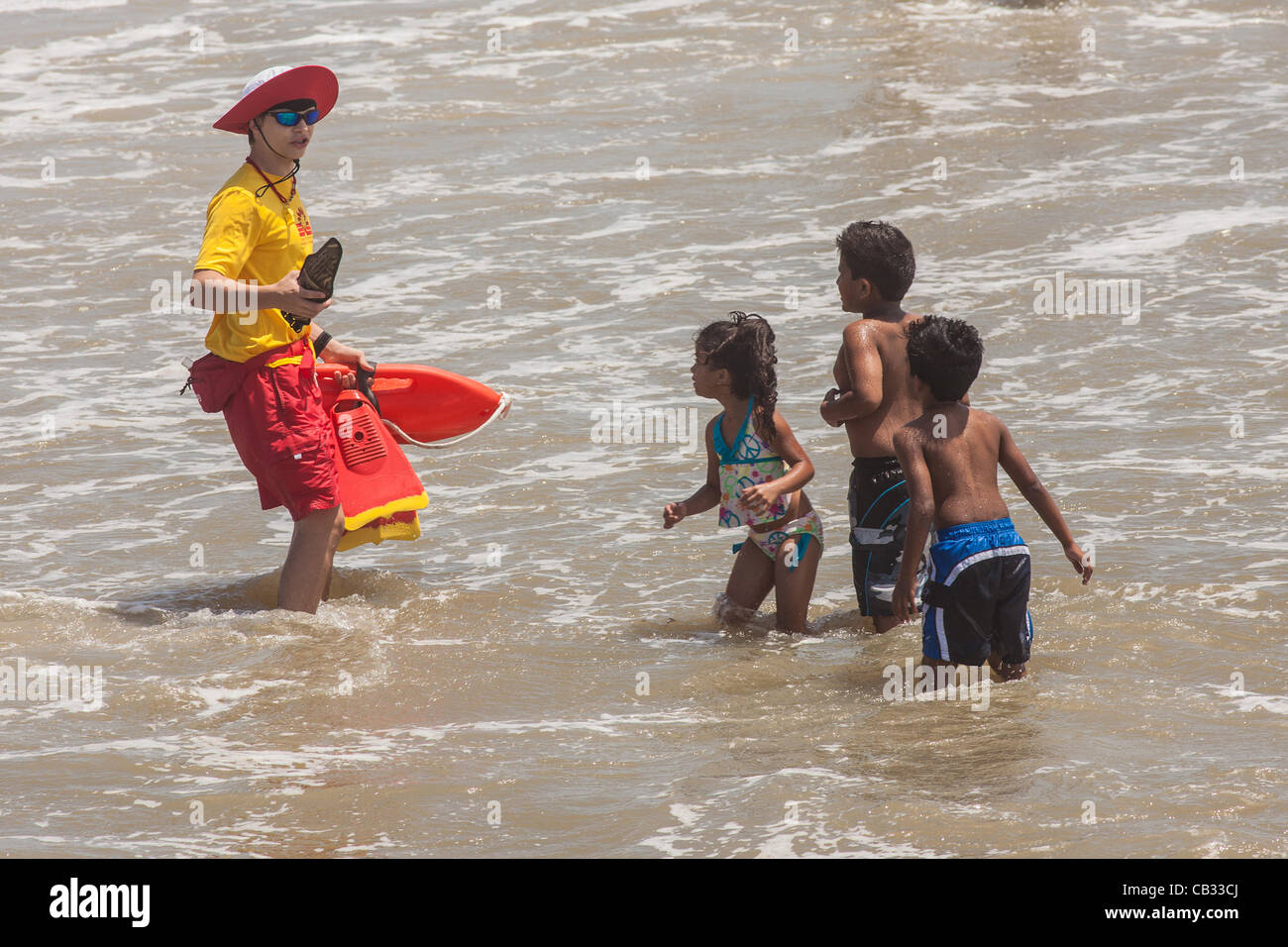 USA. A Charleston County life guard warns children to move closer to shore as Tropical Storm Beryl brushes past the South Carolina coast on May 27, 2012 in Folly Beach, South Carolina.  The storm caused local beaches to restrict swimming due to strong currents and and rip tides Stock Photo