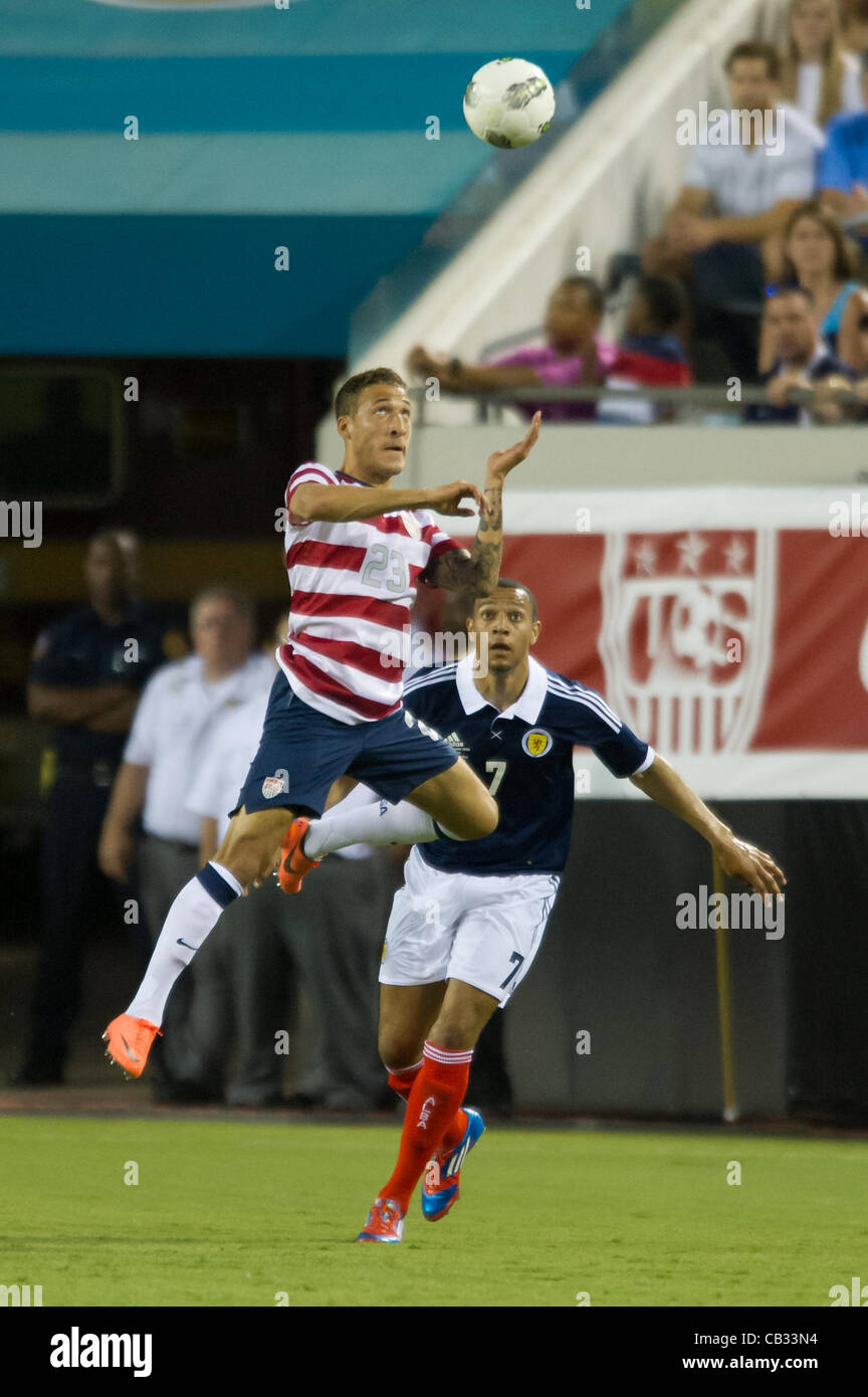 26.05.2012. Jacksonville, Florida, USA.  USA's Fabian Johnson (23) leaps into the air to head the ball over Scotland's Matt Phillips (7) during the first half of play of the U.S. Men's National Soccer Team game against Scotland at Everbank Field in Jacksonville, FL. At halftime USA lead Scotland 2-1 Stock Photo