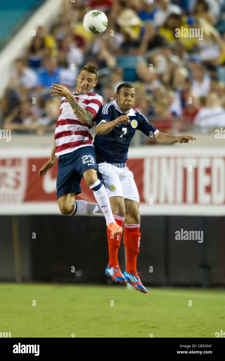 26.05.2012. Jacksonville, Florida, USA.  USA's Fabian Johnson (23) and Scotland's Matt Phillips (7) leap into the air to head the ball during the first half of play of the U.S. Men's National Soccer Team game against Scotland at Everbank Field in Jacksonville, FL. At halftime USA lead Scotland 2-1.  Stock Photo