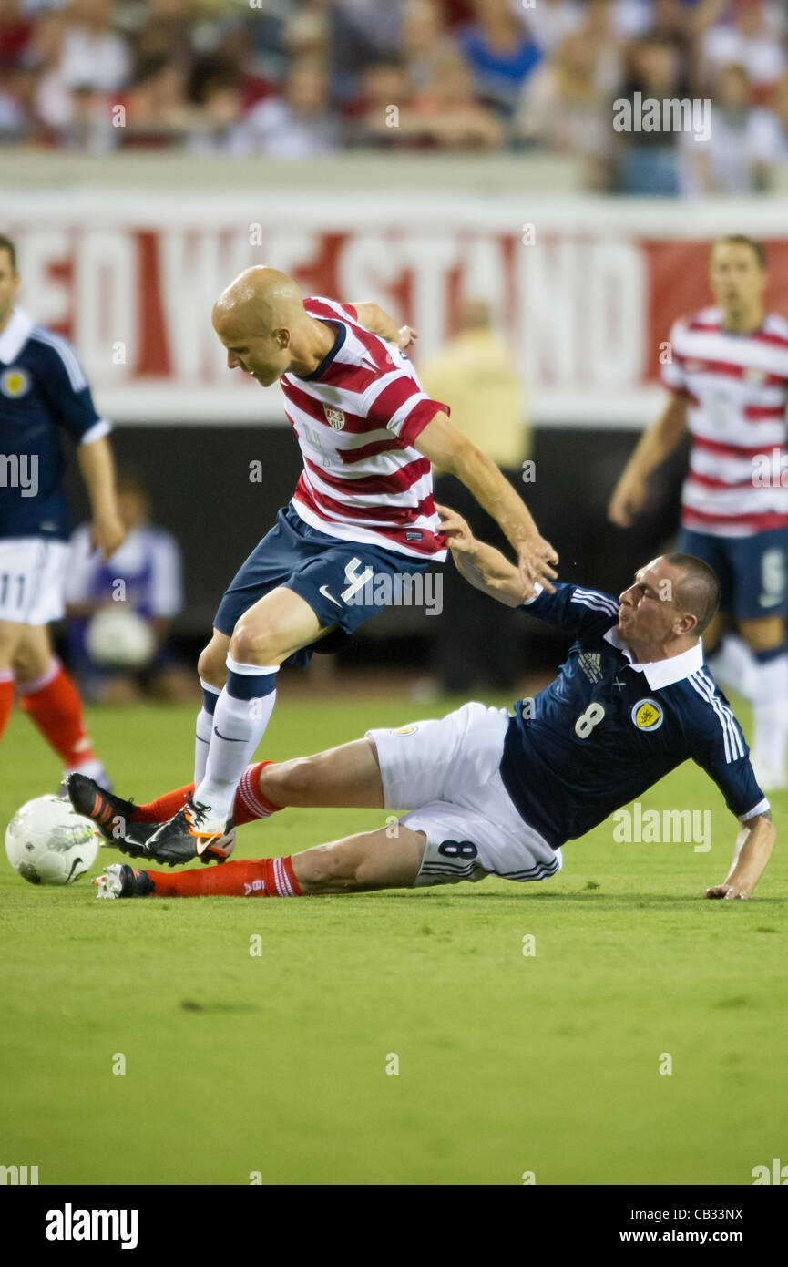 26.05.2012. Jacksonville, Florida, USA.  Scotland's Scott Brown (8) slide tackles USA's Michael Bradley (4) during the first half of play of the U.S. Men's National Soccer Team game against Scotland at Everbank Field in Jacksonville, FL. At halftime USA lead Scotland 2-1. USA ran out convincing winn Stock Photo